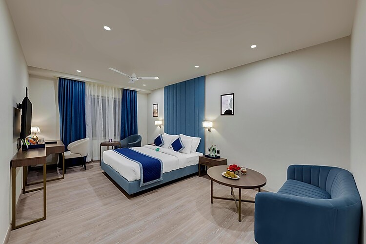 Click Collection Grand Gateway Varanasi Varanasi [Simple Sitting Area With A Chair And Table In Standard Room]